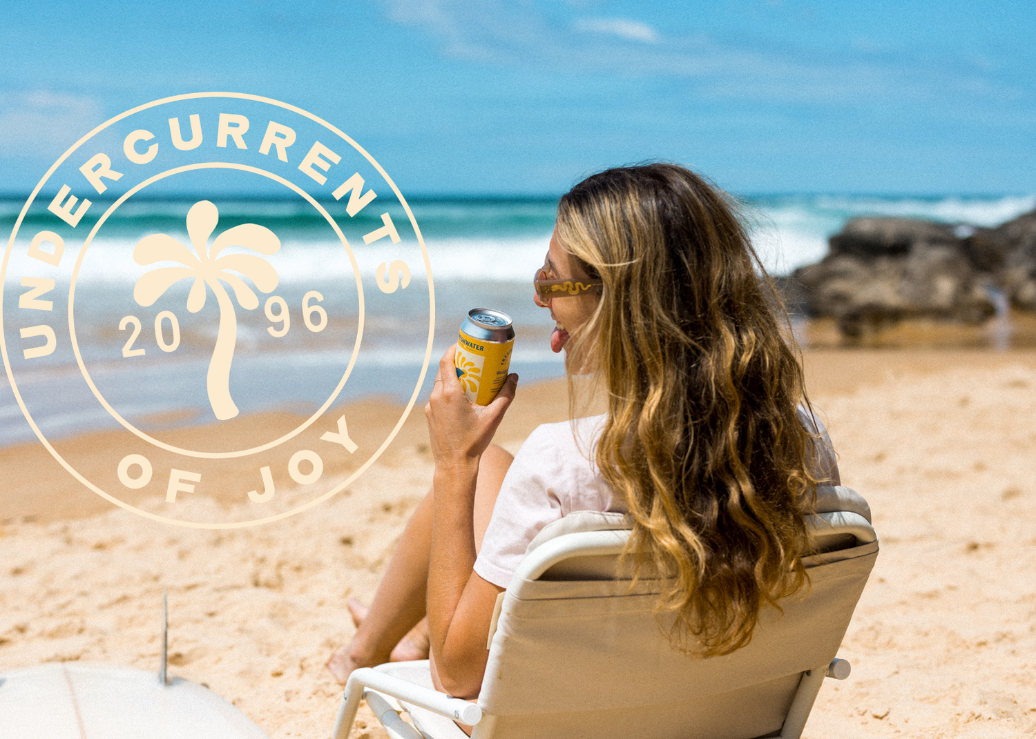 Woman drinking Freshwater Brewing beer on Freshwater Beach